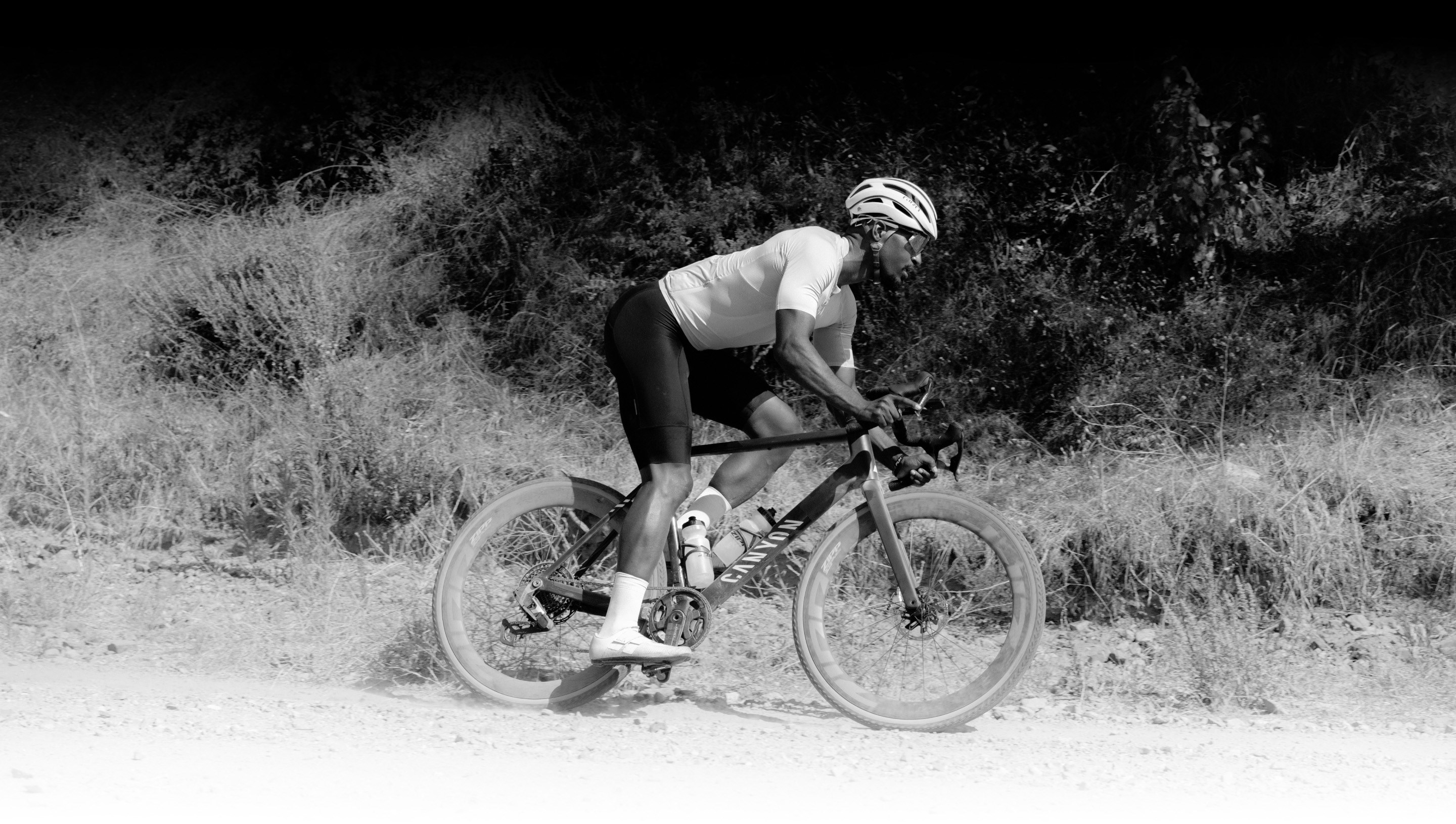 Black and white image of rider on Zipp 303 XPLR wheels.