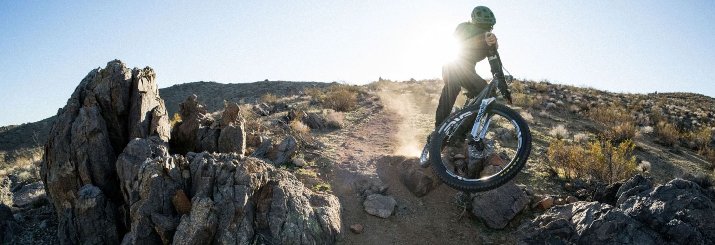 Image of MTB rider in desert landscape with sunflare