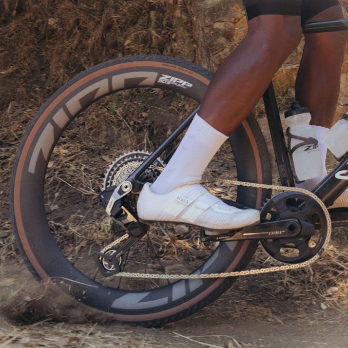 image of 303 XPLR wheel kicking up dirt on trail.