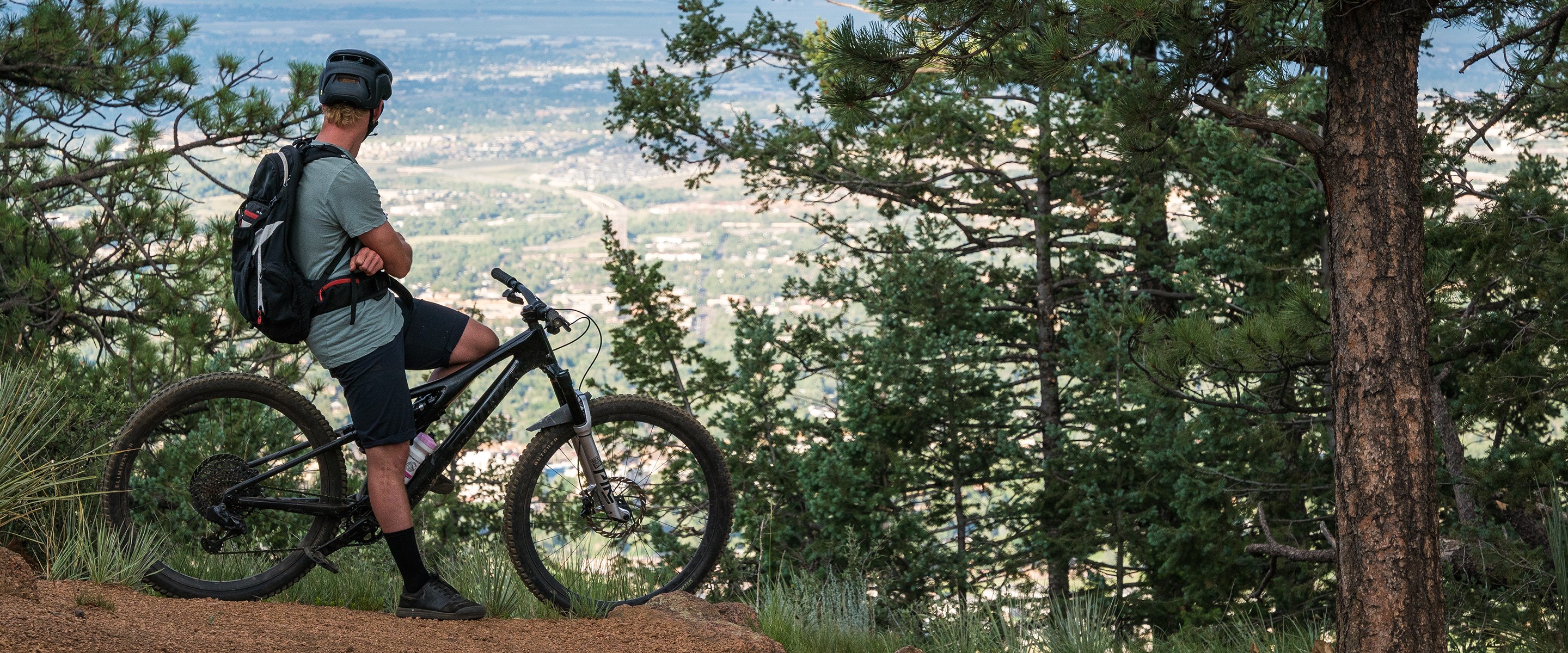 Free Radical Will looking out onto the Colorado Springs city scape from the trail.