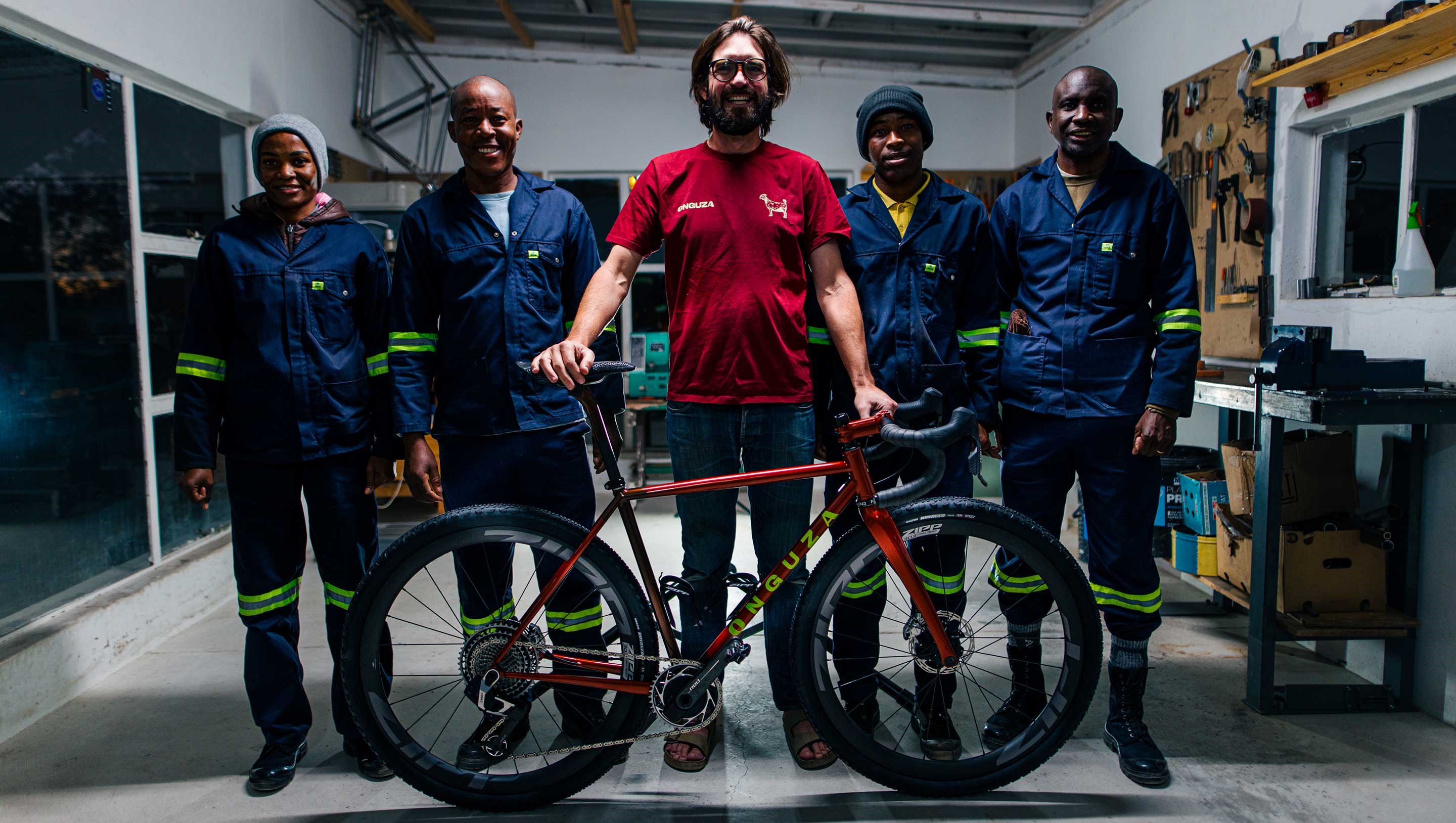 Dan Craven of Onguza Bicycles looks over Miranda's new gravel bike with RED XPLR AXS