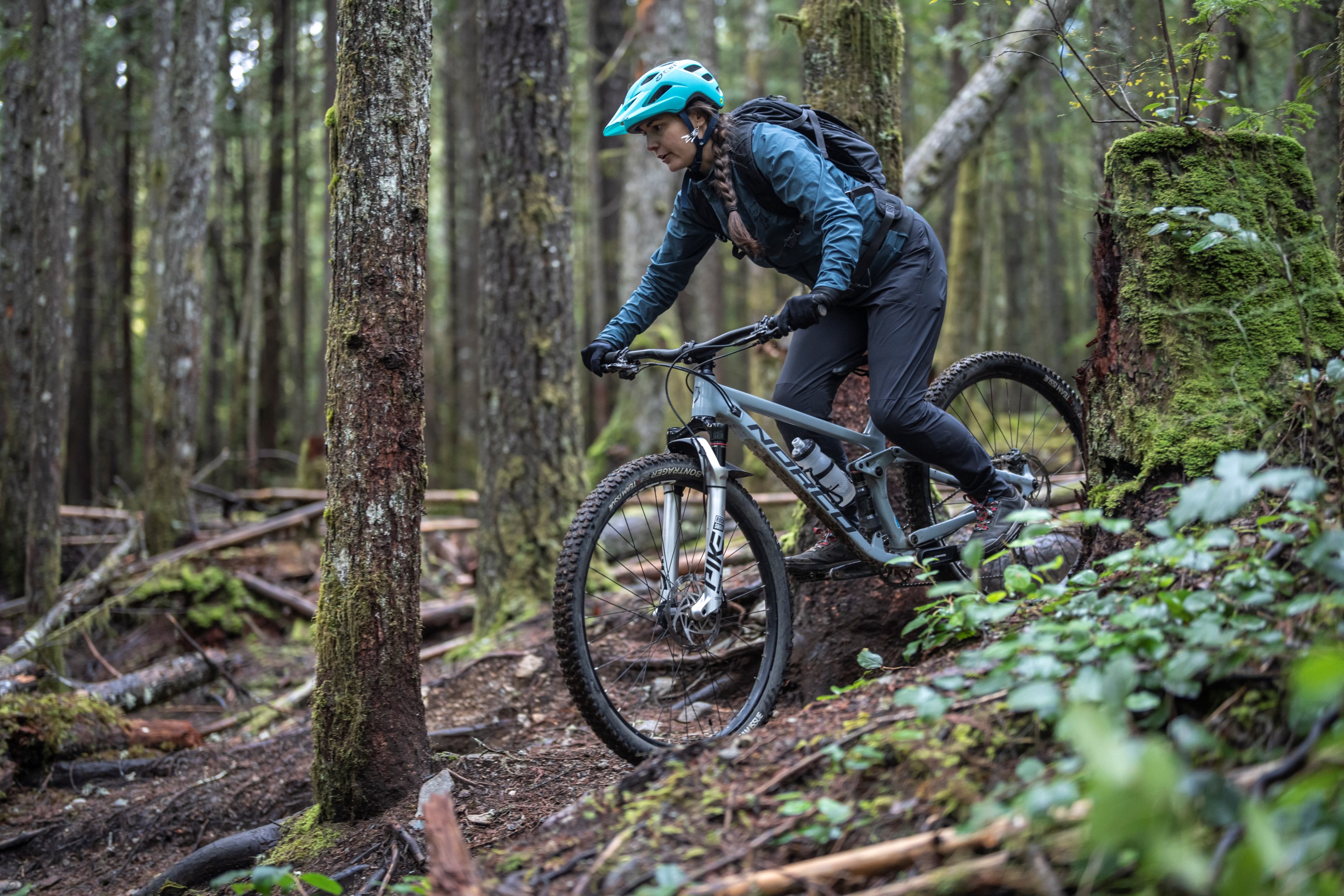 Melissa descending through trees and brush