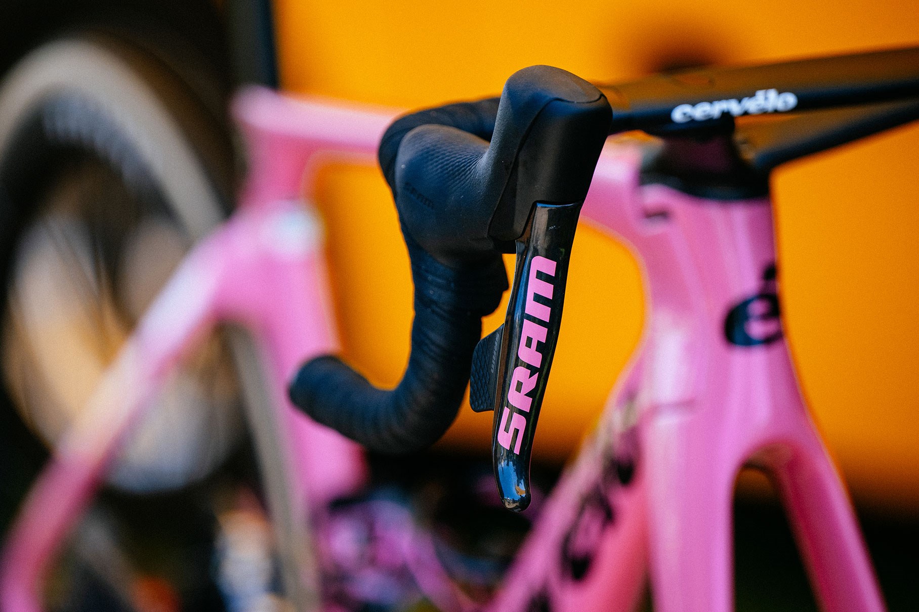 A pink SRAM RED eTap AXS shifter